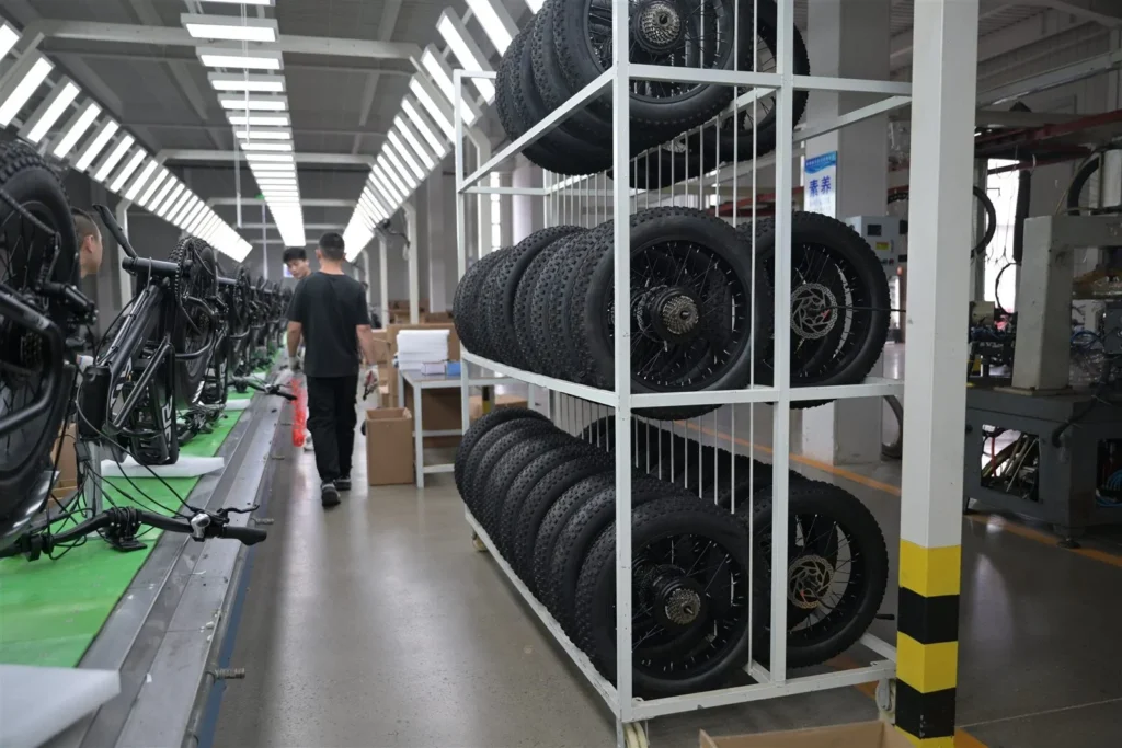Frames and wheel assemblies prepared alongside the assembly line.