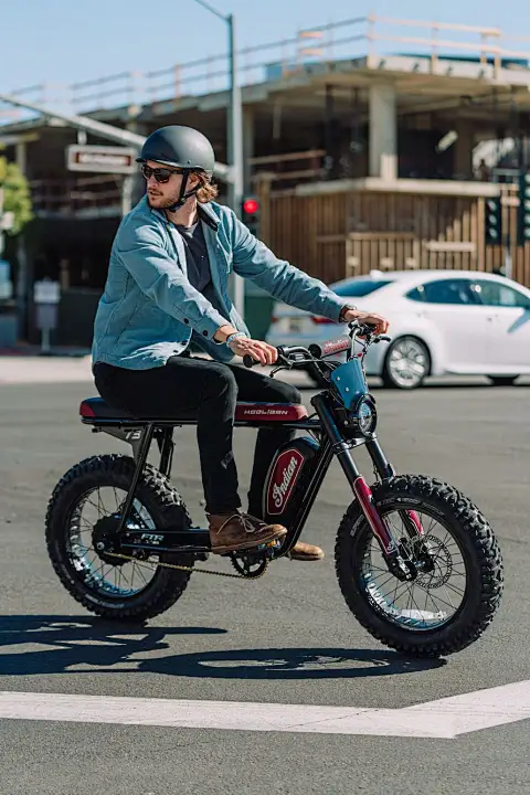 Helmeted rider on a fat-tire electric bicycle in a city street